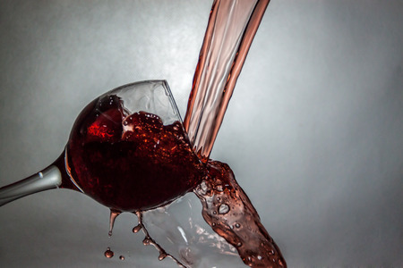 Interesting way for pouring and splashing wine in a glassの写真素材