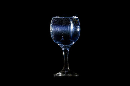 Light beam going through a glass of waterの写真素材