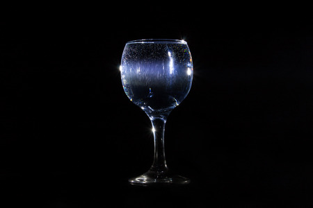 Light beam going through a glass of waterの写真素材