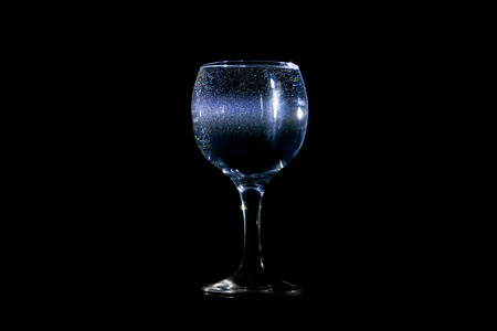 Light beam going through a glass of waterの写真素材