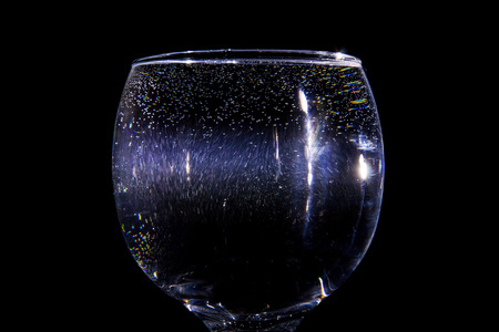 Light beam going through a glass of waterの写真素材