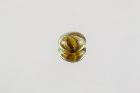 Multi Colored gem on a reflective surface. Beautiful glassworkの写真素材