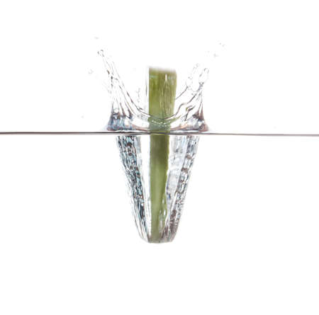 Cucumber slice falling in the waterの写真素材