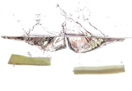 Cucumber slice falling in the waterの写真素材