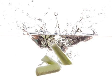 Cucumber slice falling in the waterの写真素材