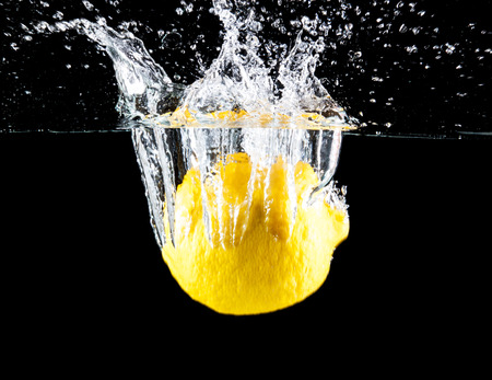 Lemon falling underwater. Clean and vibrant.の写真素材