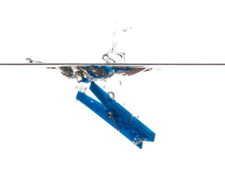 Blue Clothespin splashing and sinking underwaterの写真素材