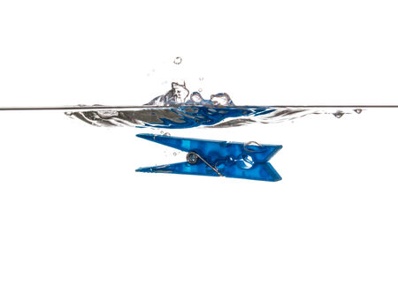 Blue Clothespin splashing and sinking underwaterの写真素材