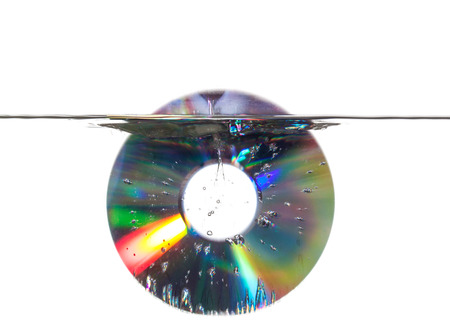 Compact disk sinking in waterの写真素材
