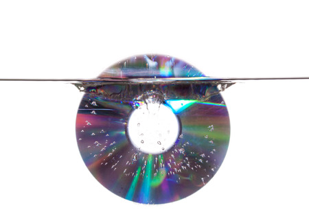 Compact disk sinking in waterの写真素材