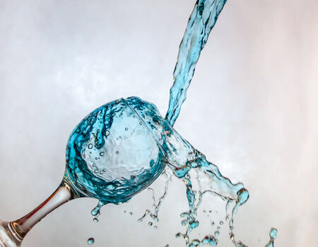 Interesting way for pouring blue drink in a glassの写真素材