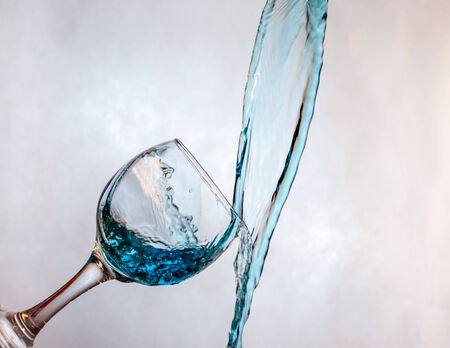 Interesting way for pouring blue drink in a glassの写真素材