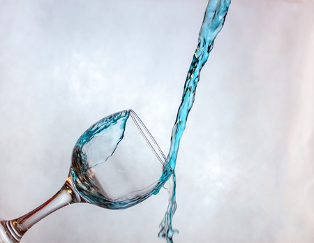 Interesting way for pouring blue drink in a glassの写真素材