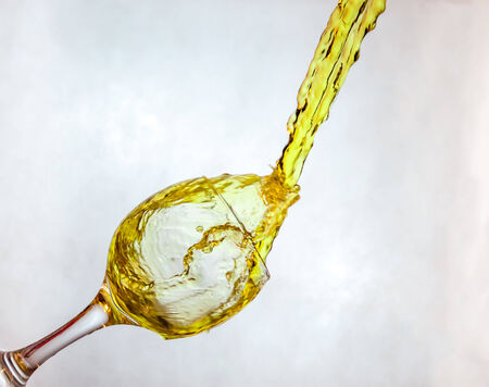 Interesting way for pouring yellow drink in a glassの写真素材