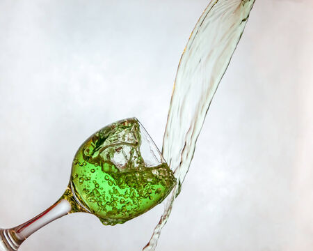 Interesting way for pouring green drink in a glassの写真素材
