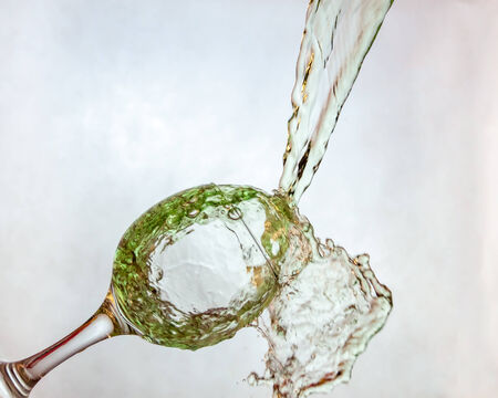 Interesting way for pouring green drink in a glassの写真素材