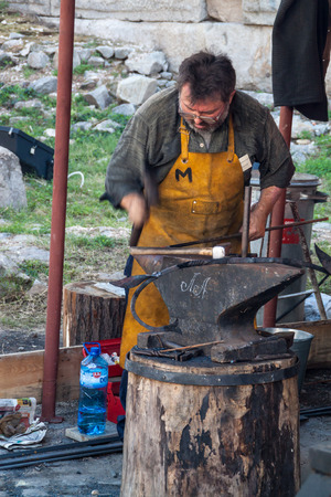 Blacksmith working on his next masterpieceのeditorial素材