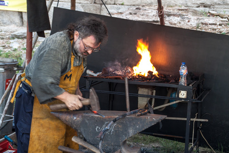 Blacksmith working on his next masterpieceのeditorial素材