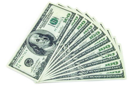 Paper clips spreaded over hundred dollar bills isolated on a white backgroundの写真素材