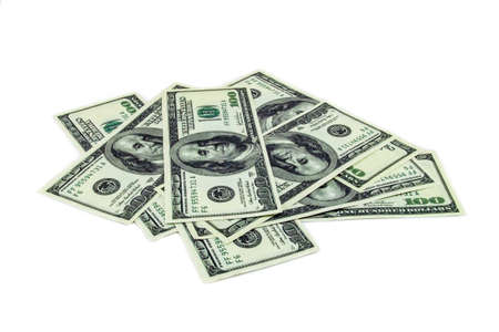 Pile of one hundred dollar bills on a white backgroundの写真素材