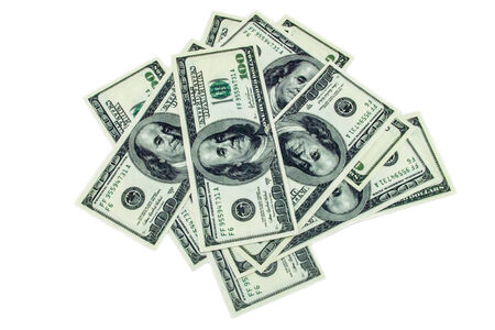 Pile of one hundred dollar bills on a white backgroundの写真素材