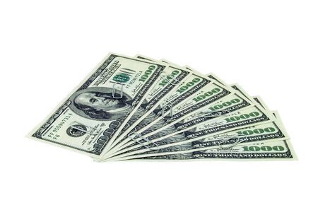 Paper clips spreaded over one thousand dollar bills isolated on a white backgroundの写真素材