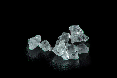 Extreme macro photography of sugar crystals on a black backgroundの写真素材
