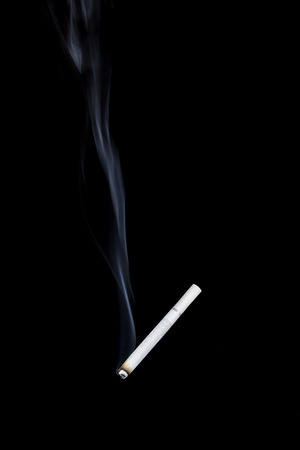 Smoking cigarette isolated on a black backgroundの写真素材