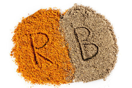 Grinded Red and Black pepper closeup isolated on white backgroundの写真素材