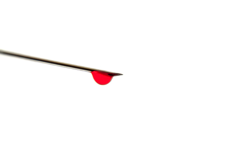 Extreme macro of a needle with a drop of blood on itの写真素材