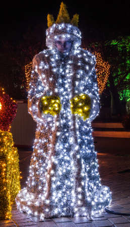 Snow White statue decorated with Christmas lightsの写真素材
