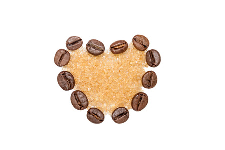 Heart shape made from coffee beans filled with brown sugarの写真素材