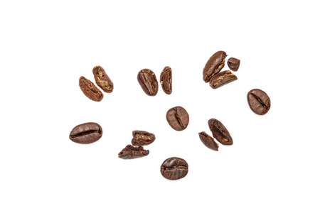 Whole and broken coffee beans isolated on whiteの写真素材