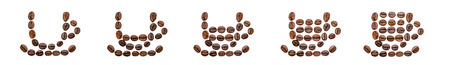 Five coffee cups arranged from beans and filled with different amountsの写真素材