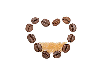 Heart shape made from coffee beans filled with brown sugarの写真素材