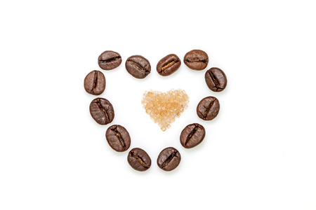Heart shape made from coffee beans and brown sugarの写真素材