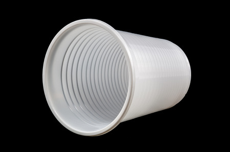 White plastic cup isolated on a black backgroundの写真素材