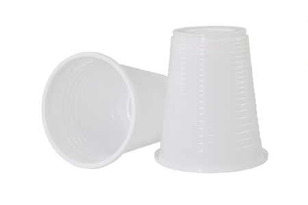 Two white and ribbed plastic cupsの写真素材