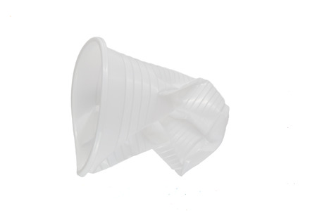 Crushed white plastic cup on a white backgroundの写真素材