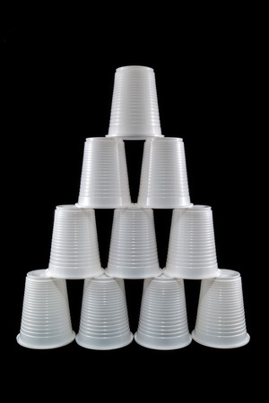 Pyramid made of plastic cups isolated on blackの写真素材