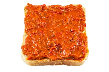 Traditional Bulgarian relish called Lutenica. Spread on a slice of white bread.の写真素材