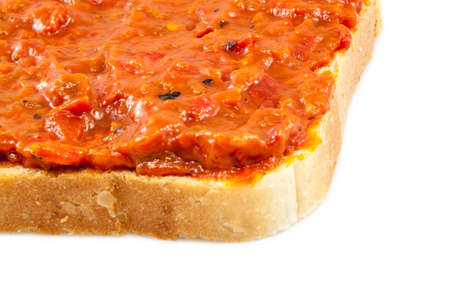 Traditional Bulgarian relish called Lutenica. Spread on a slice of white bread.の写真素材