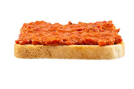 Traditional Bulgarian relish called Lutenica. Spread on a slice of white bread.の写真素材