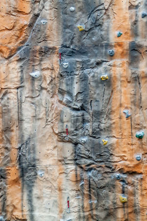 Multicolored climbing wall with support equipment on it.の写真素材