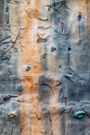 Multicolored climbing wall with support equipment on it.の写真素材