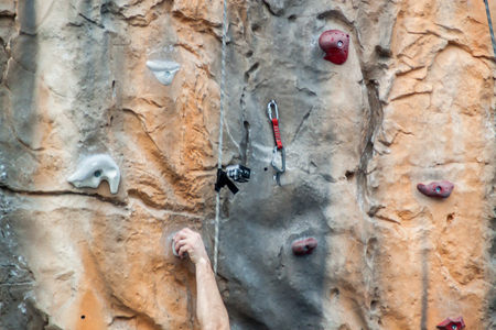 Human hand gripping on a climbing wall.の写真素材