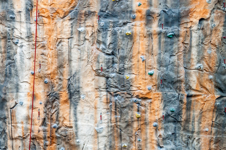 Multicolored climbing wall with support equipment on it.の写真素材