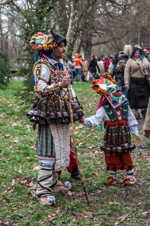 YAMBOL, BULGARIA - MARCH 08, 2015 - Kukerlandia - mask festival and masquerade games 08 March 2015. Bulgarian traditional dances and costumes called Kukeri.のeditorial素材