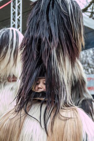 YAMBOL, BULGARIA - MARCH 08, 2015 - Kukerlandia - mask festival and masquerade games 08 March 2015. Bulgarian traditional dances and costumes called Kukeri.のeditorial素材