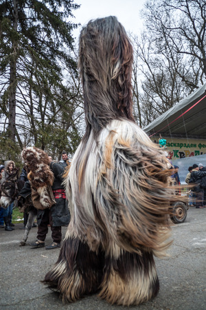 YAMBOL, BULGARIA - MARCH 08, 2015 - Kukerlandia - mask festival and masquerade games 08 March 2015. Bulgarian traditional dances and costumes called Kukeri.のeditorial素材